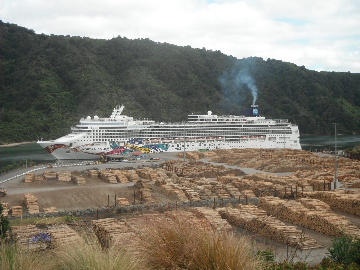 Norwegian Jewel berthed at Waimahara Wharf, with the Shakespeare Bay log yard in front.