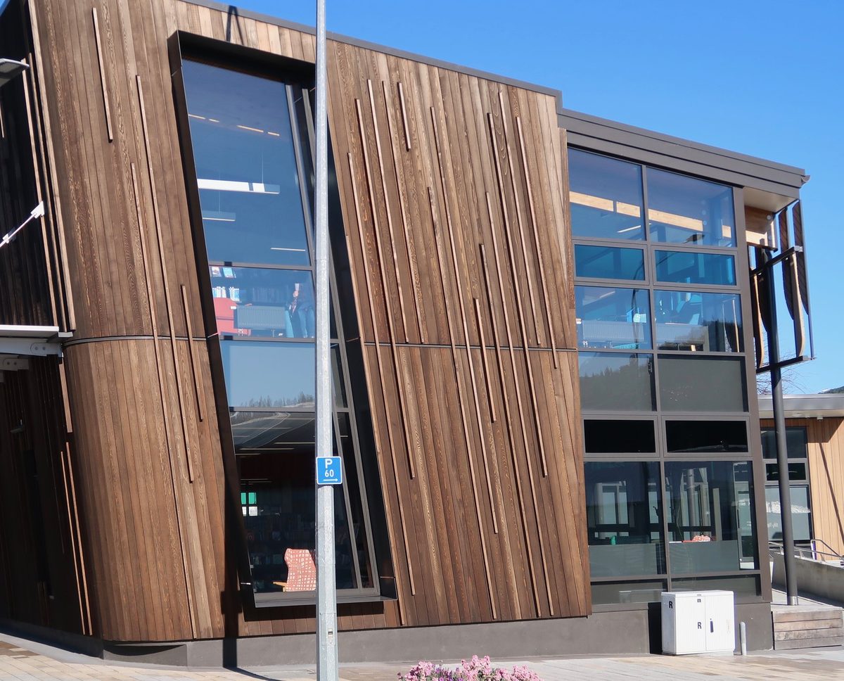 Closer street-level view of Picton Library's angular timber cladding and tall glazed windows.