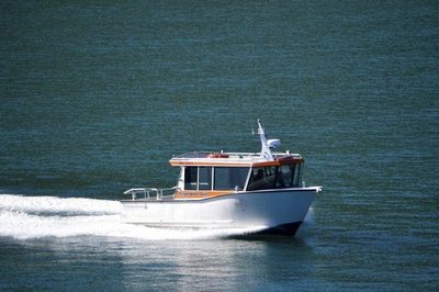A Picton Water Taxis launch underway on Queen Charlotte Sound, with the operator name visible on the cabin.