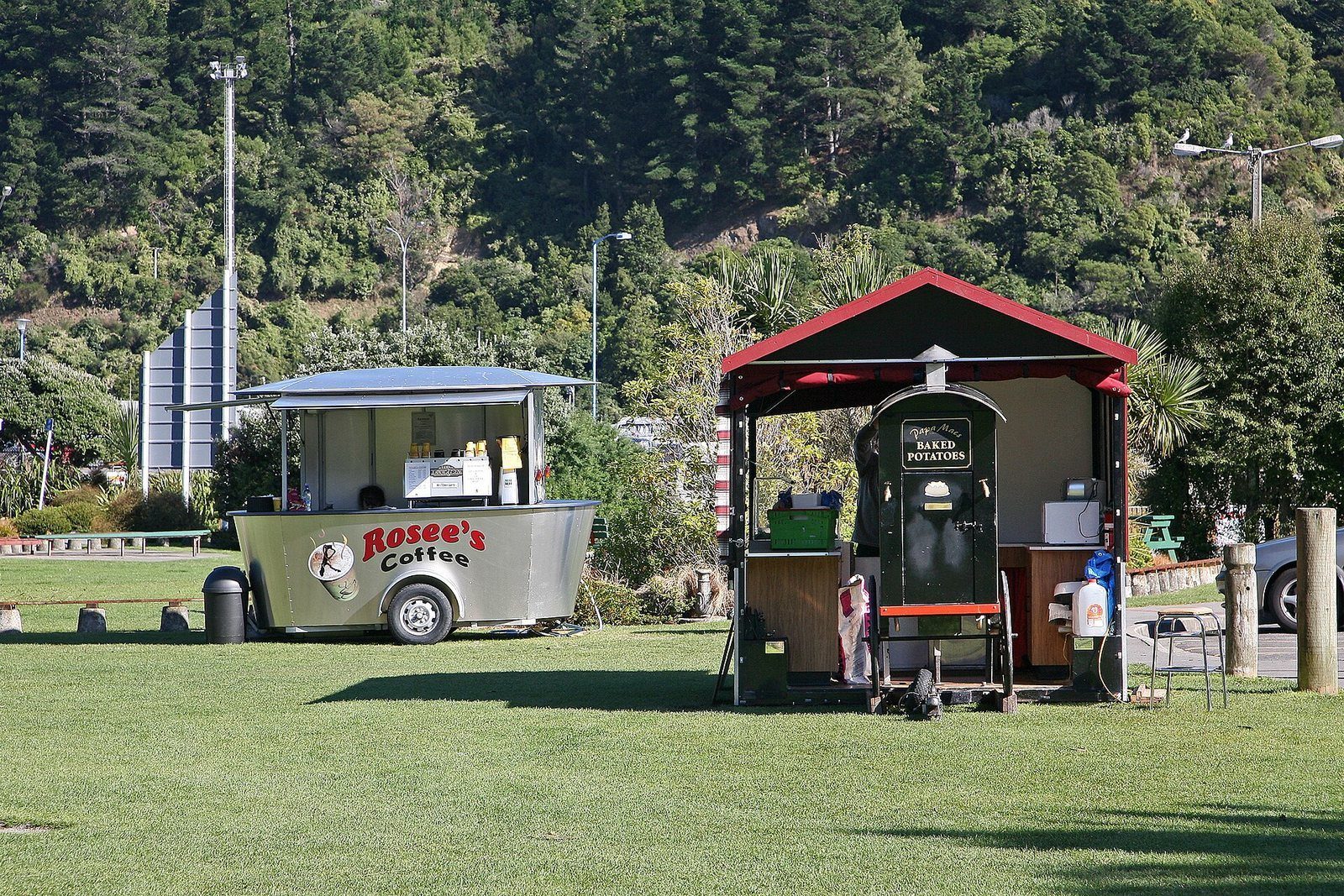 Two small food and coffee carts parked on the grass of the Picton foreshore